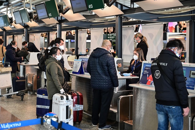 Hành khách làm thủ tục lên máy bay tại sân bay quốc tế Milan-Malpensa ở phía tây bắc Milan. Ảnh: AFP